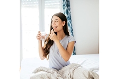 Image A lady taking a supplements